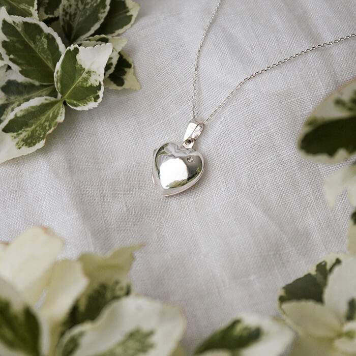 heart locket with cubic zirconia on a white background