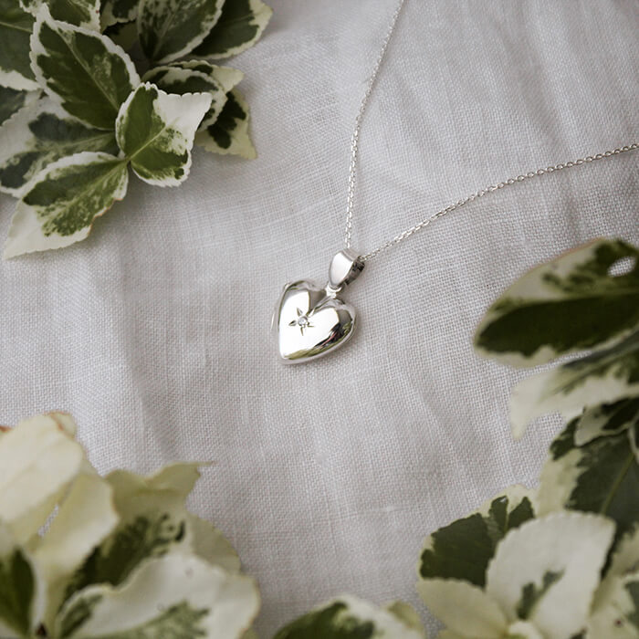 Heart-shaped photo locket on white