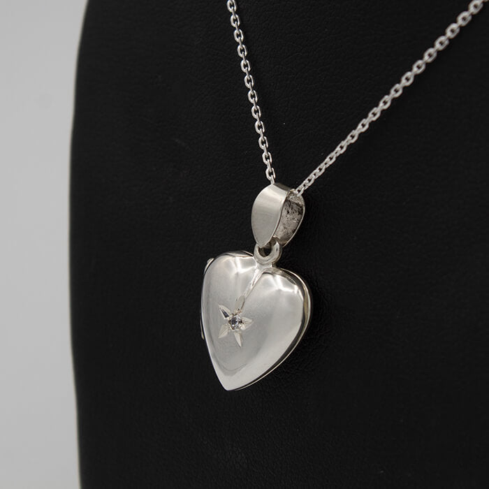heart shaped photo locket on a black background