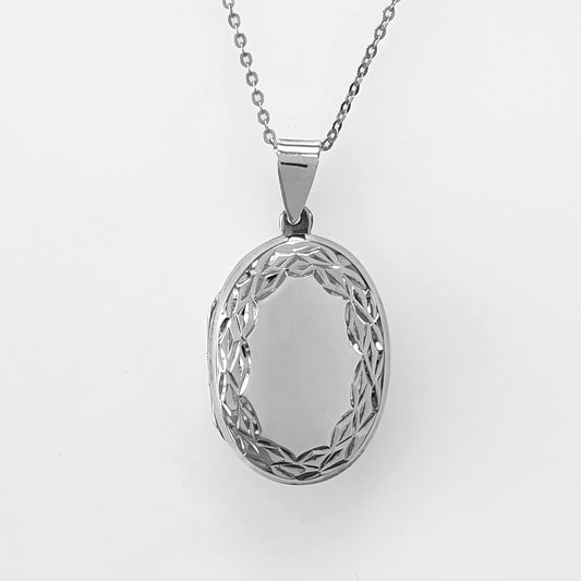 Large oval locket with silver chain on a white background. Sterling silver