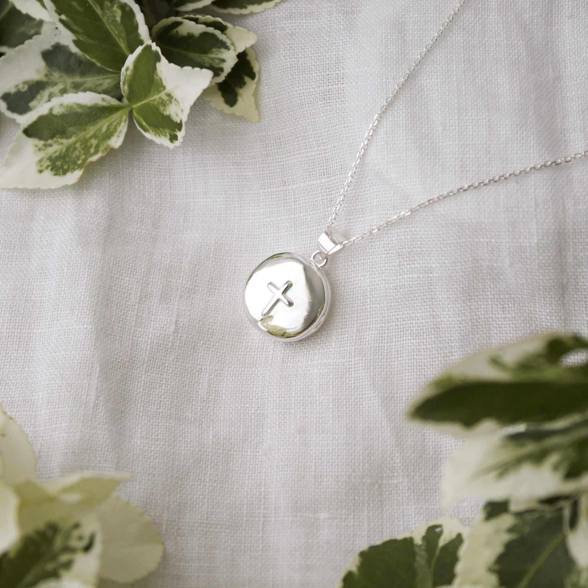 round locket with cross on a white background