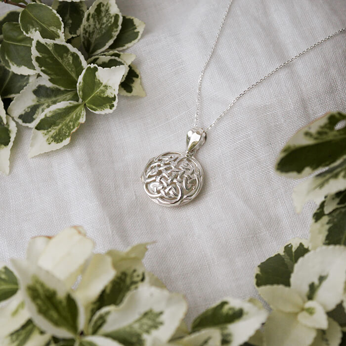 Large celtic silver locket on a white background
