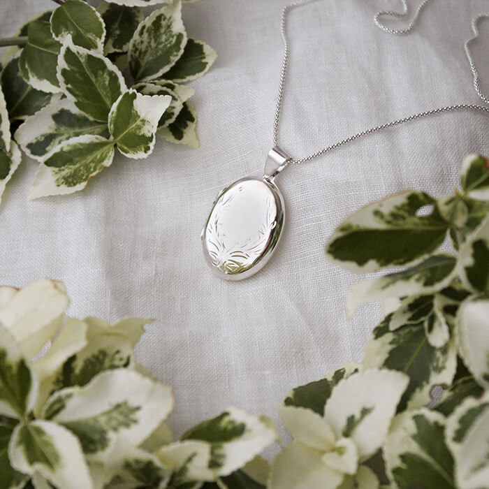 large oval locket ona white linen background