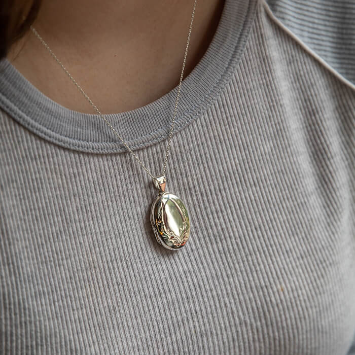 Model wearing large oval locket