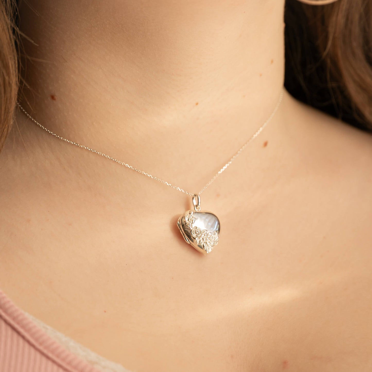Heart-shaped pendant necklace on a person's neck