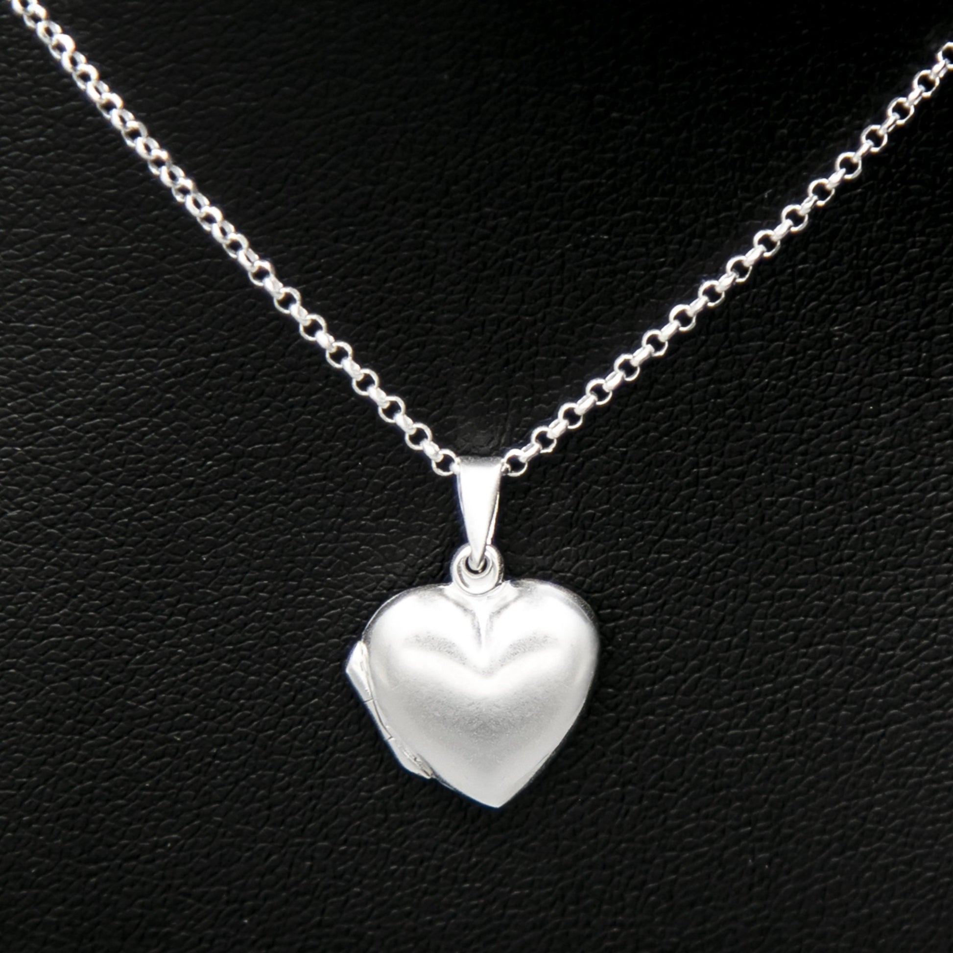 Silver heart shaped photo locket necklace on Italian silver chain against black background